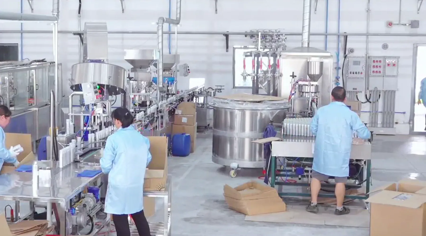 Aerosol filling equipment, production conveyors and workers at the Huajie manufacturing facility.